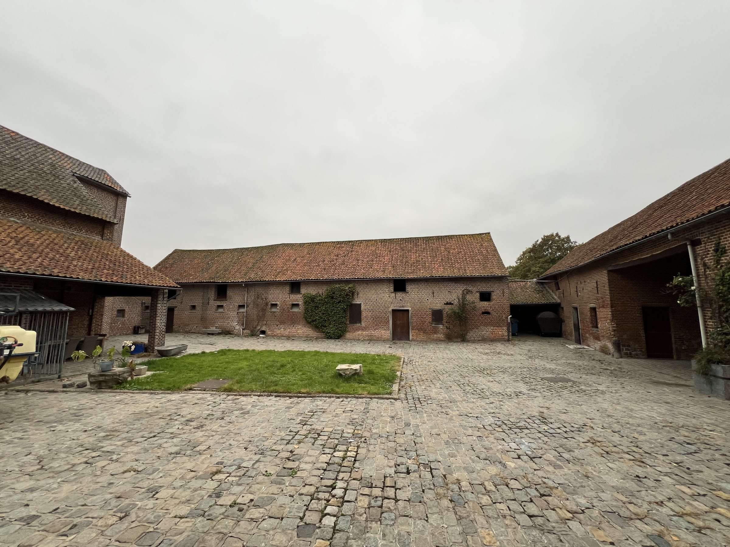 The cobbled courtyard with its lawn, barns all around