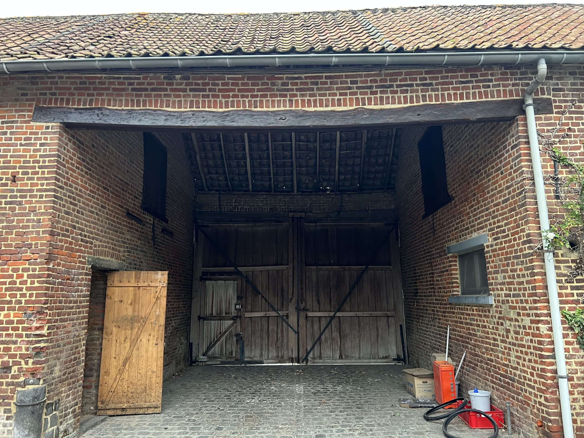 Open barn with its wooden gate, for the team cars